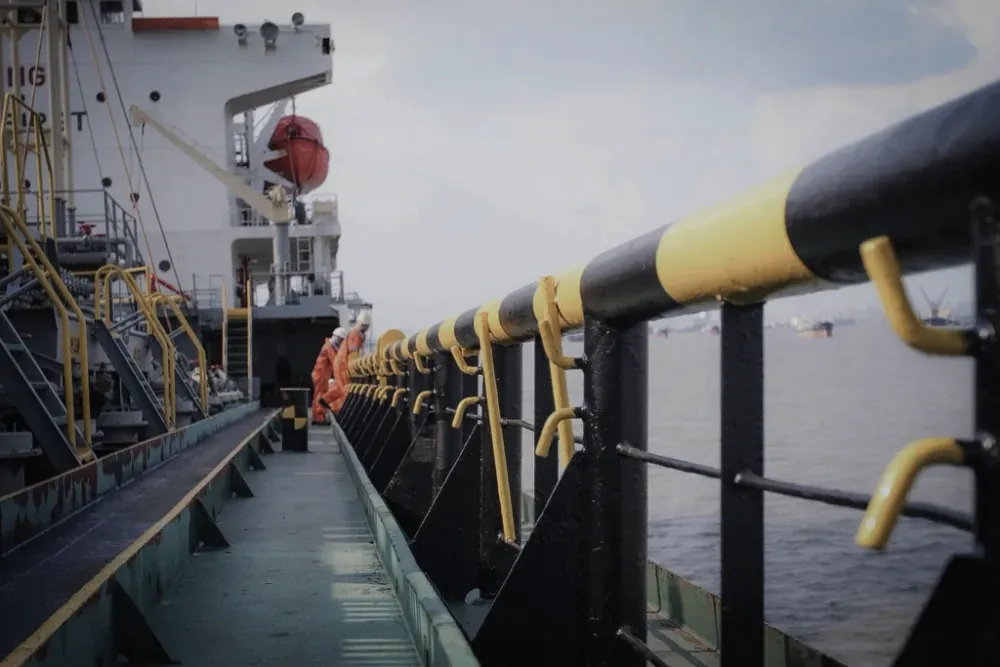 Industrial pipework and manifolds on a tanker deck handling hazardous cargo