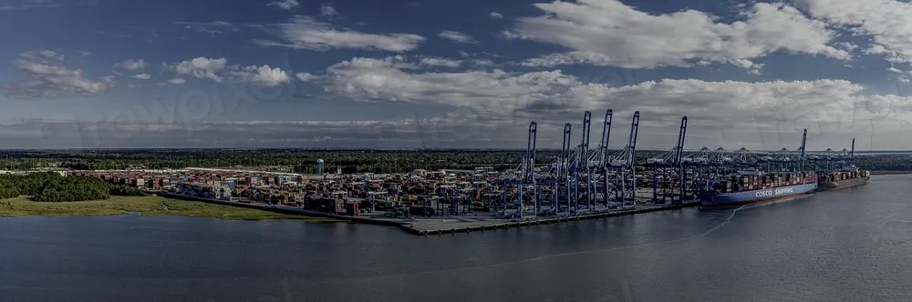 Aerial view of a container terminal with gantry cranes and stacked containers