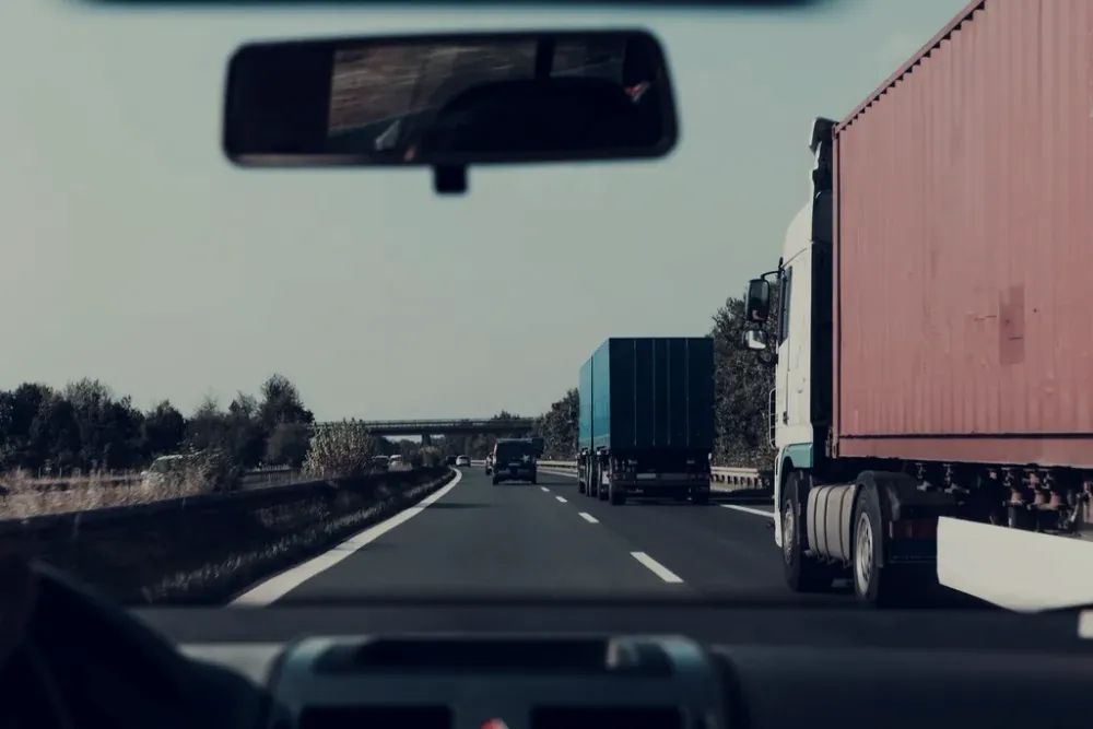 A container truck on the highway heading to port